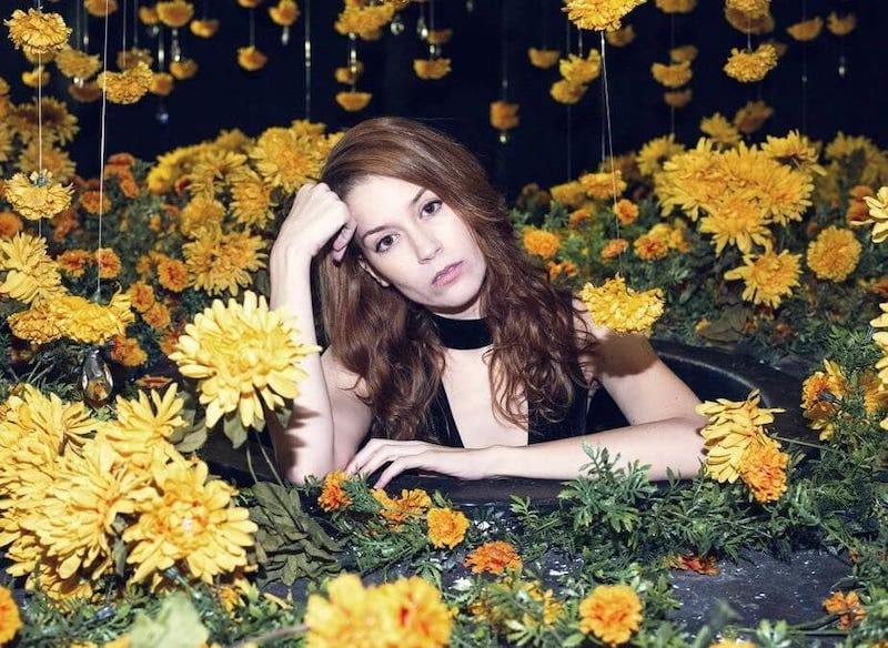 woman surrounded by flowers