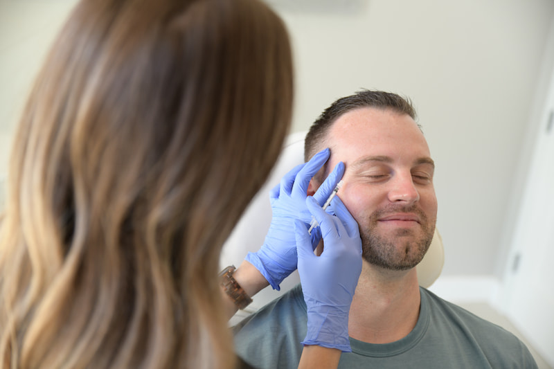 Man getting botox injections around eyes at Beyond Aesthetics