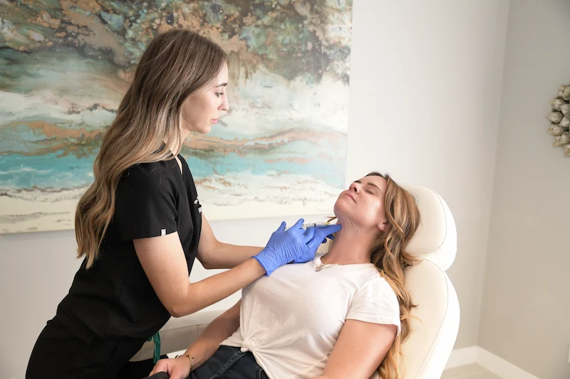 Aesthetician at b|A injecting Kybella into a client